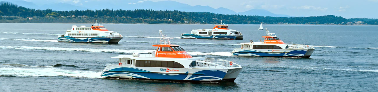 Kitsap Transit Fast Ferry Fleet image of four boats in water with mountain backdrop